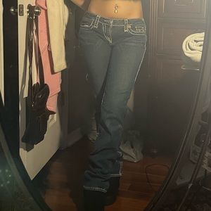 low rise True religion jeans with white stitching and a wide leg.